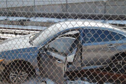 close up view of car from side with driver door open sitting on metro tracks