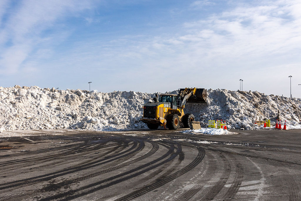 snow is cleared and deposited in the parking lot of the RFK stadium on Jan. 31, 2026 in D.C.
