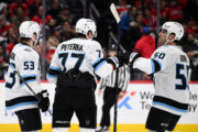 Utah Mammoth right wing JJ Peterka (77) celebrates his goal with left wing Michael Carcone (53) and defenseman Sean Durzi (50) during the second period of an NHL hockey game against the Washington Capitals, Tuesday, March 3, 2026, in Washington. (AP Photo/Nick Wass)