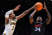 Howard guard Bryce Harris (34), right, rises to the basket as UMBC forward DJ Armstrong (3), left, defends during the second half in a First Four college basketball game in the NCAA Tournament, Tuesday, March 17, 2026, in Dayton, Ohio. (AP Photo/Kareem Elgazzar)