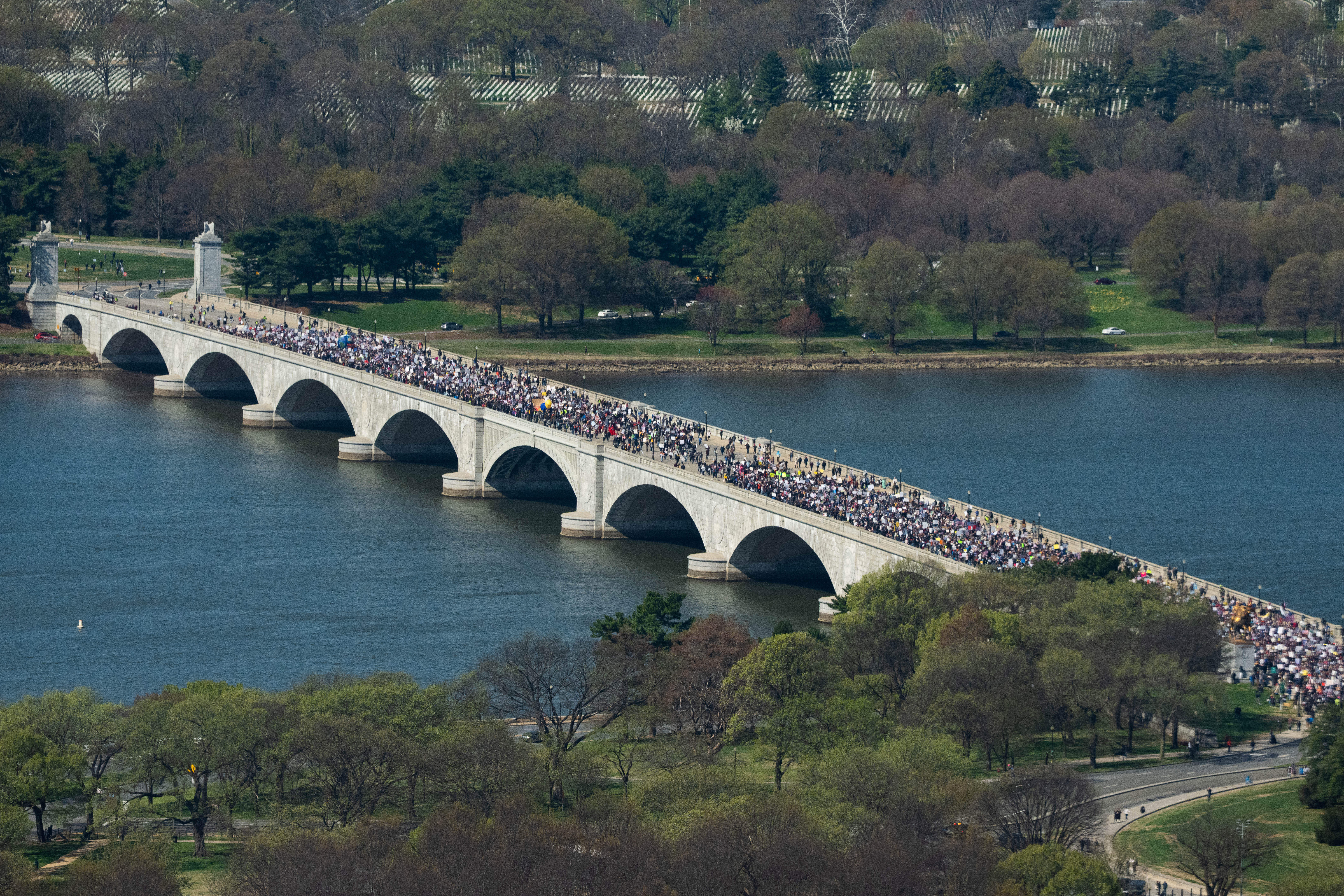 Demonstrators march across Memorial Bridge during the No Kings protest in Washington, Saturday, March 28, 2026. (AP Photo/Allison Robbert)