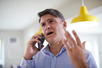 A stock image of man complaining on the phone.