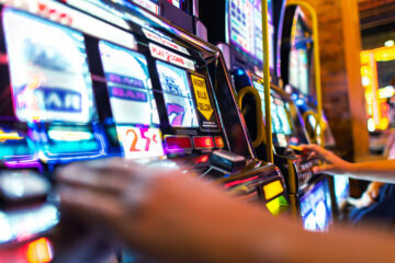 Brightly colored screens of casino slot machines