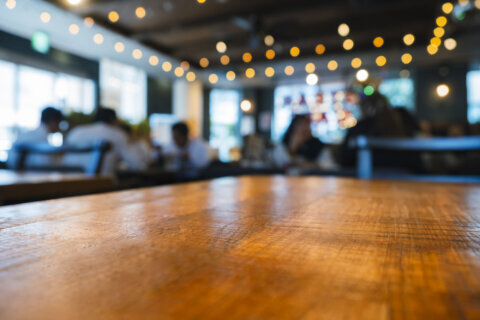 Table top wooden counter Bar with people interior restaurant Blur background