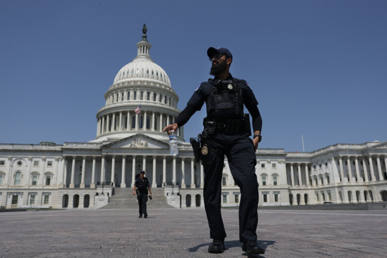 police stand in front of capitol building
