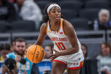 woman holds basketball during game