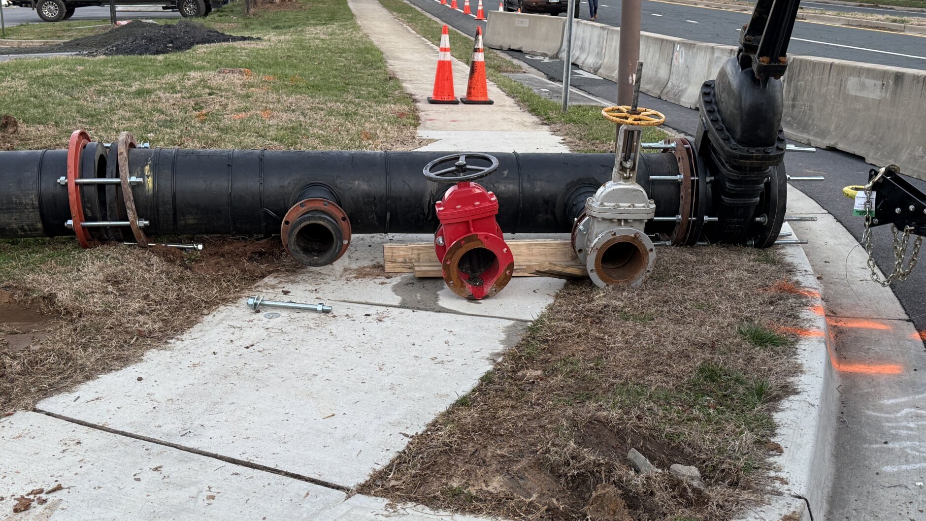 pipe laying on sidewalk