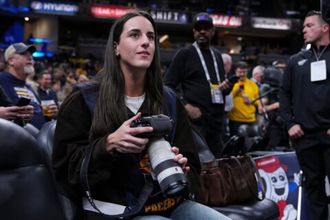 Caitlin Clark works as a photographer for the Indiana Pacers as they host LeBron and the Lakers