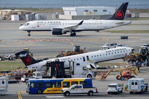 Mangled plane in LaGuardia crash is towed from runway as most injured passengers leave hospital