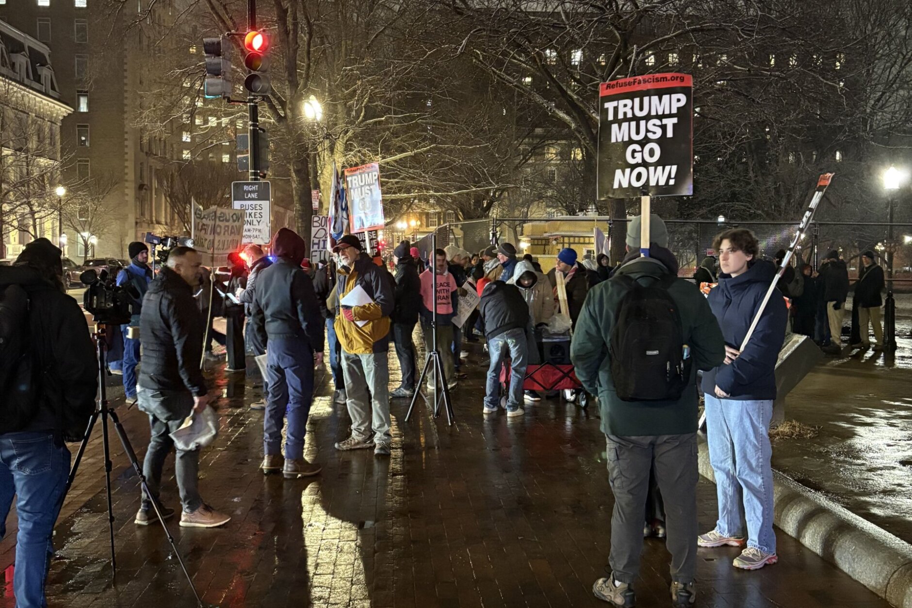 'Trump must go now' sign held by protester outside the White House, on Monday, March 2, 2026.