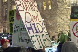 'Bombs don't hide files' sign held by protester outside the White House, on Monday, March 2, 2026.