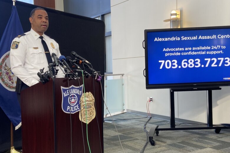 man stands behind a podium at a news conference