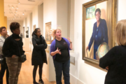 Woman tour guide leading a group at a museum.