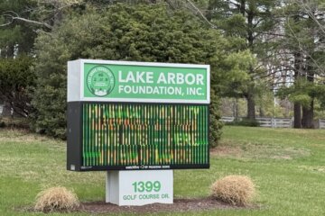 a digital sign outside on green grass