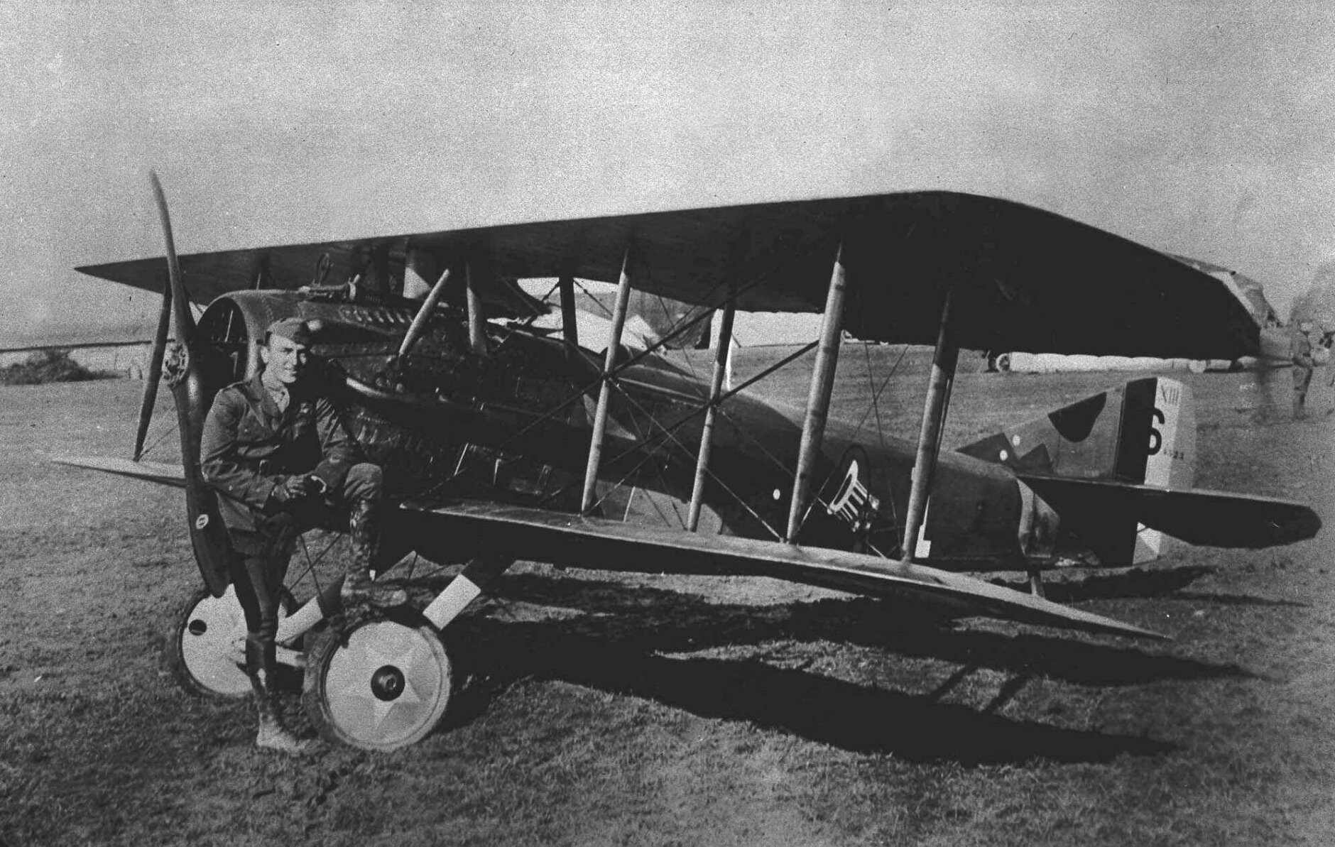 American World War I fighter pilot Eddie Rickenbacker poses with his Spad plane