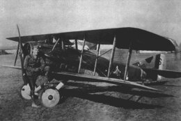 American World War I fighter pilot Eddie Rickenbacker poses with his Spad plane