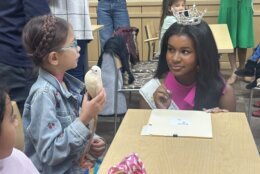 miss teen maryland listens to a young child at a workshop
