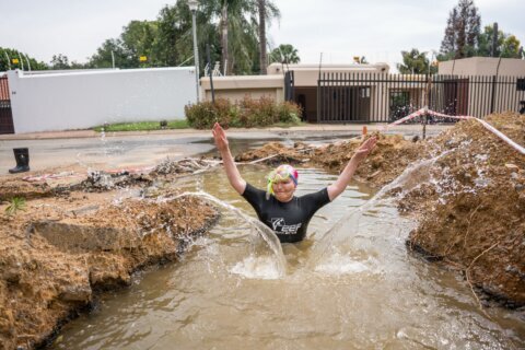 A South African politician goes snorkeling in a giant pothole to highlight city management failures