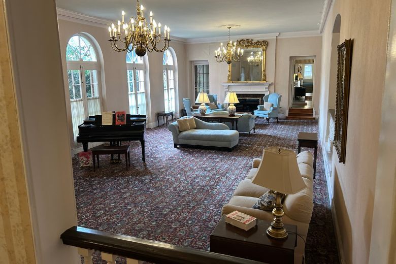 living room with couches, chairs and chandeliers
