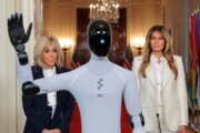 US first lady Melania Trump and French first lady Brigitte Macron look at a humanoid robot, as Trump hosts a roundtable event on the second day of the inaugural Fostering the Future Together Global Coalition Summit, at the White House on Wednesday.