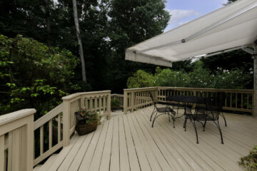 A wooden deck outside of a home.