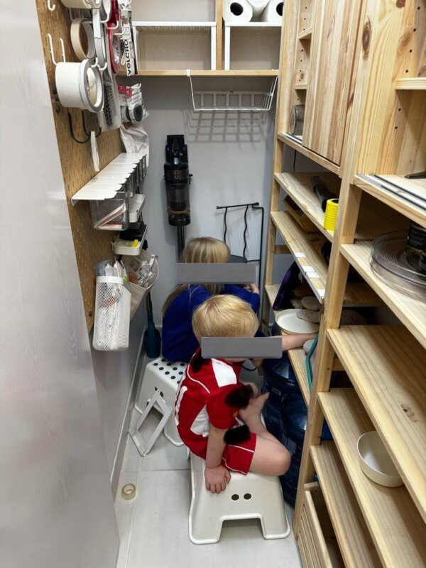 kids sitting in kitchen pantry