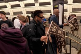 employees pass out pennants to riders