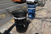 The city's current trash cans are open topped.