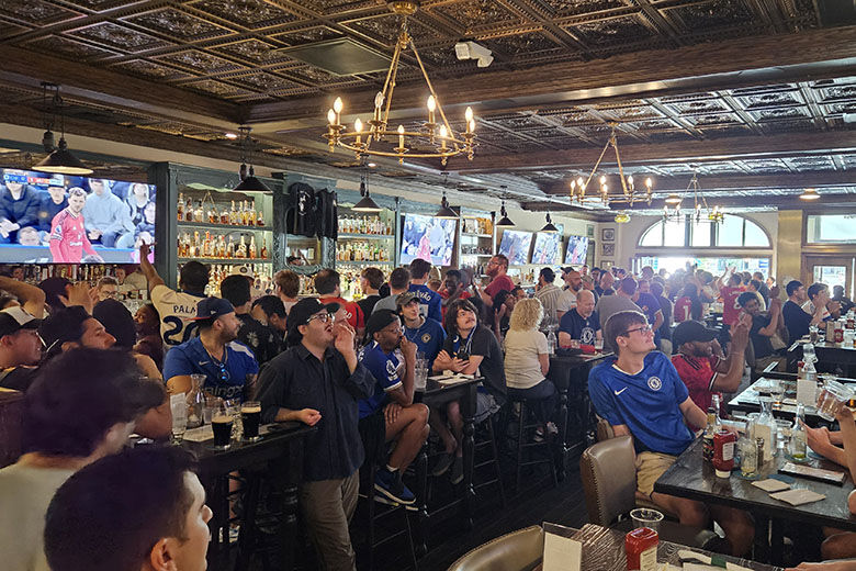 soccer fans watch game in pub
