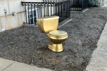 golden toilet outside building