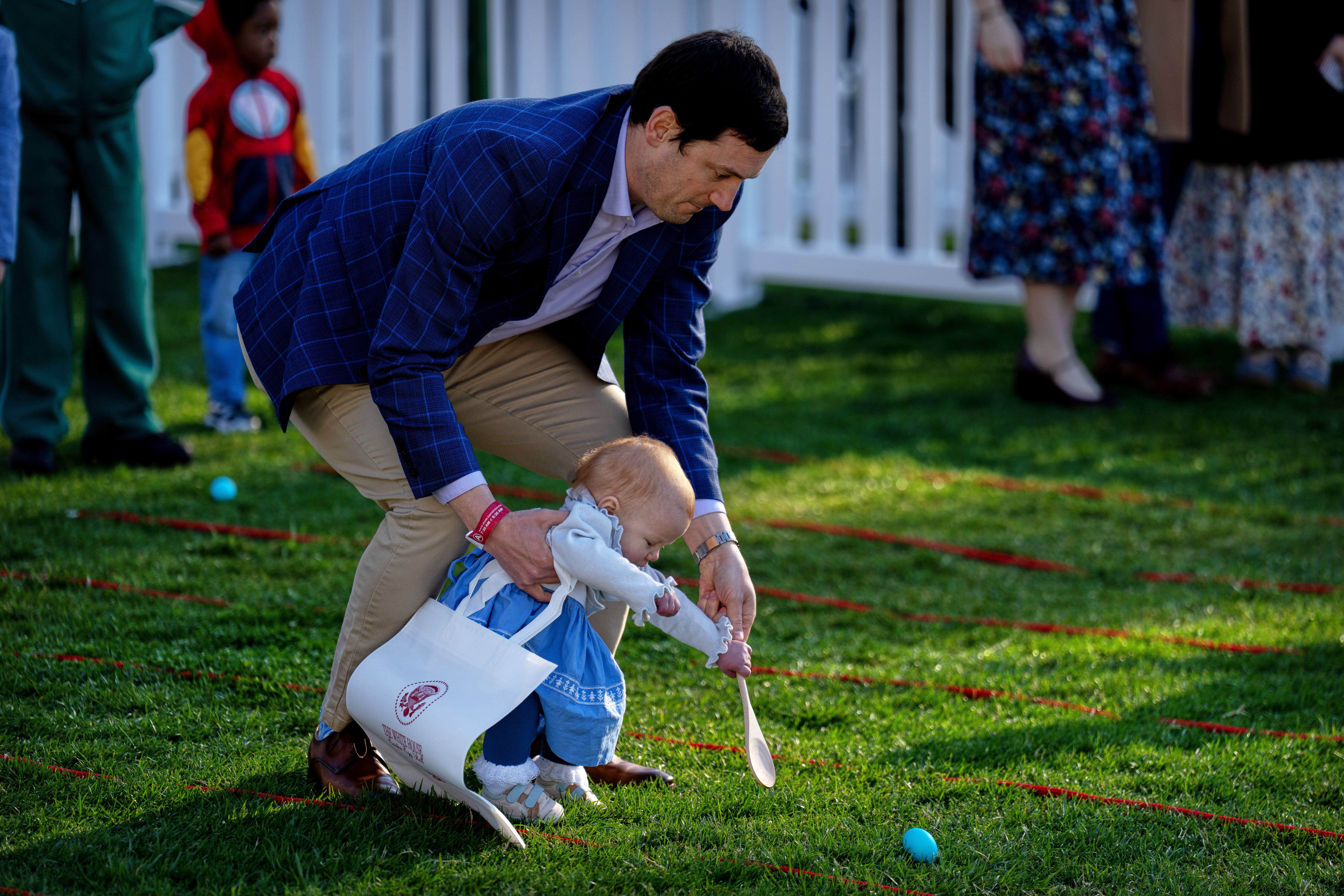 A man and baby participate in the egg roll competition during the White House Easter Egg Roll