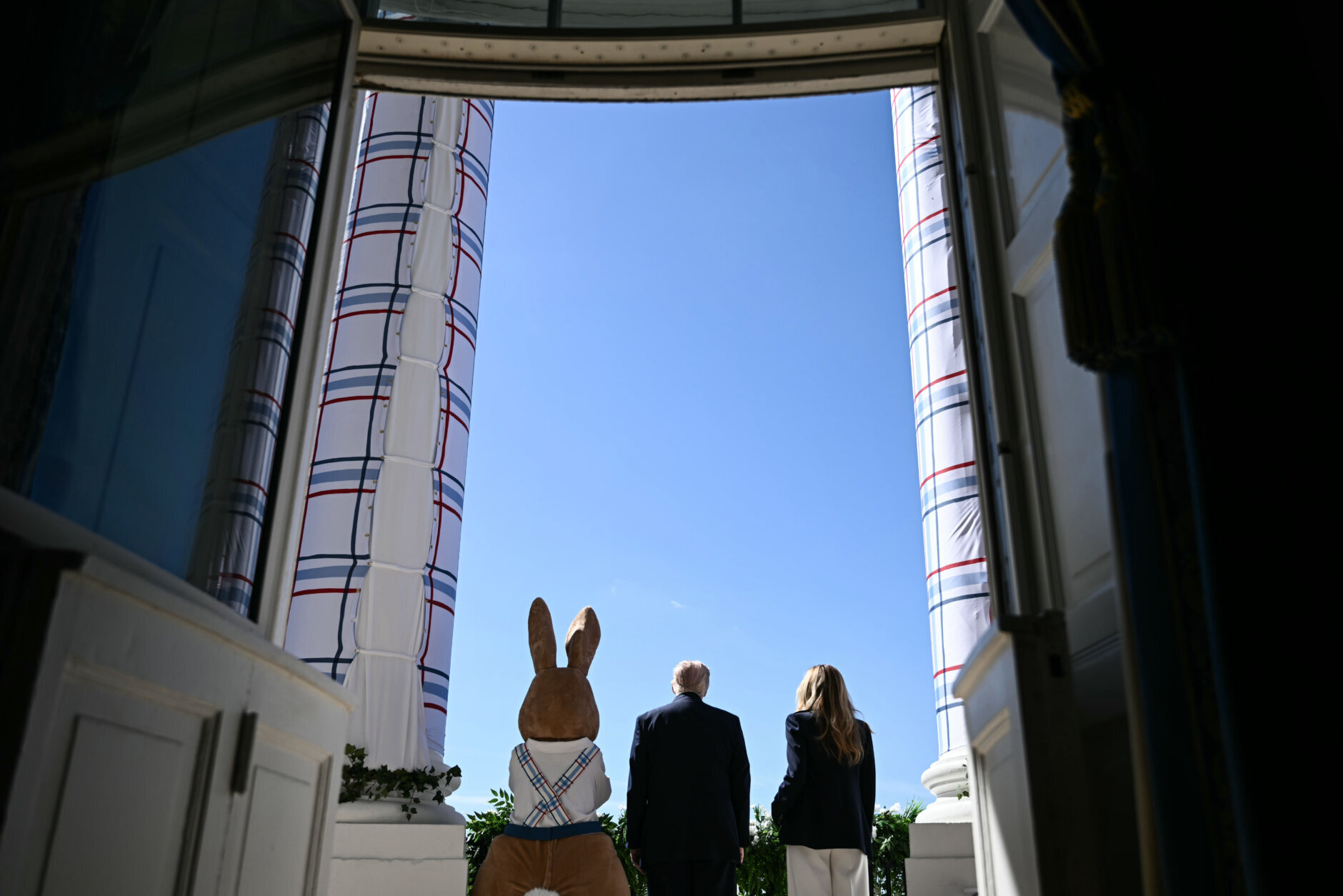 the easter bunny stands with President Donald Trump and first lady Melania Trump
