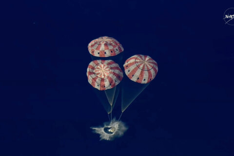 In this image from video provided by NASA, the Artemis II Orion capsule splashes down in the Pacific Ocean, on Friday, April 10, 2026. (NASA via AP)