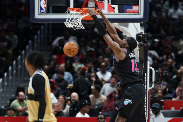 Miami Heat center Bam Adebayo, right, dunks during the first half of an NBA basketball game against the Washington Wizards, Friday, April 10, 2026, in Washington. (AP Photo/Terrance Williams)