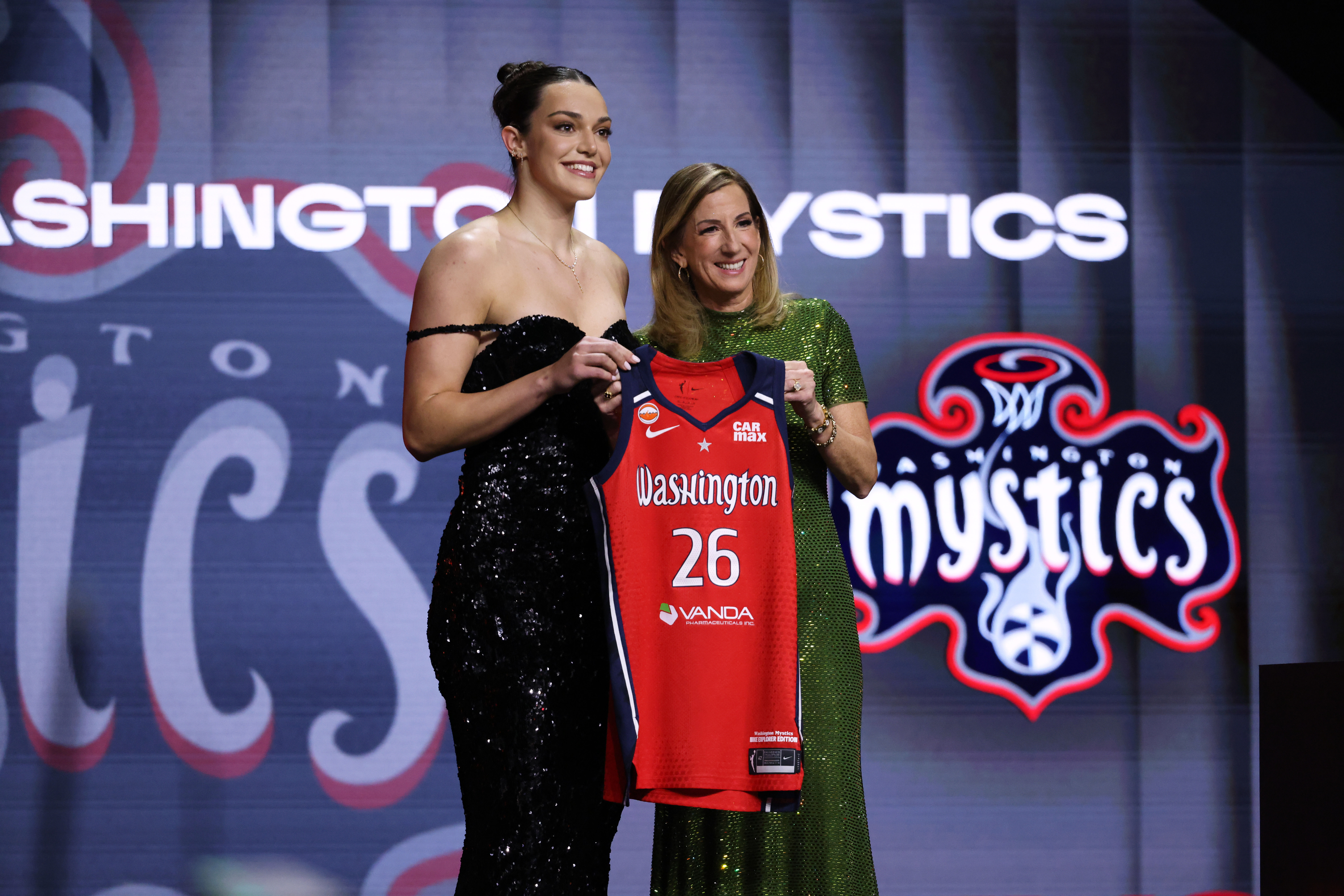 UCLA Angela Dugalic poses with WNBA commissioner Cathy Engelbert after being selected ninth overall by the Washington Mystics in the first round of the WNBA basketball draft Monday, April 13, 2026, in New York. (AP Photo/Pamela Smith)