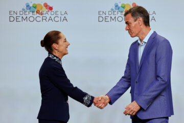 Spain's Prime Minister Pedro Sanchez greets Mexican President Claudia Sheinbaum