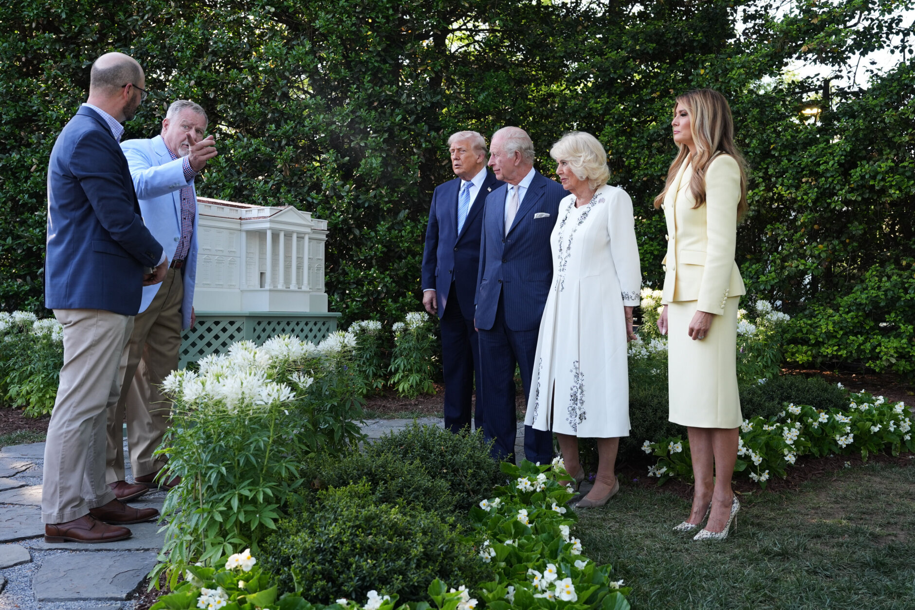 President Donald Trump and first lady Melania Trump along with Britain's King Charles III and Queen Camilla look at the White House bee hive