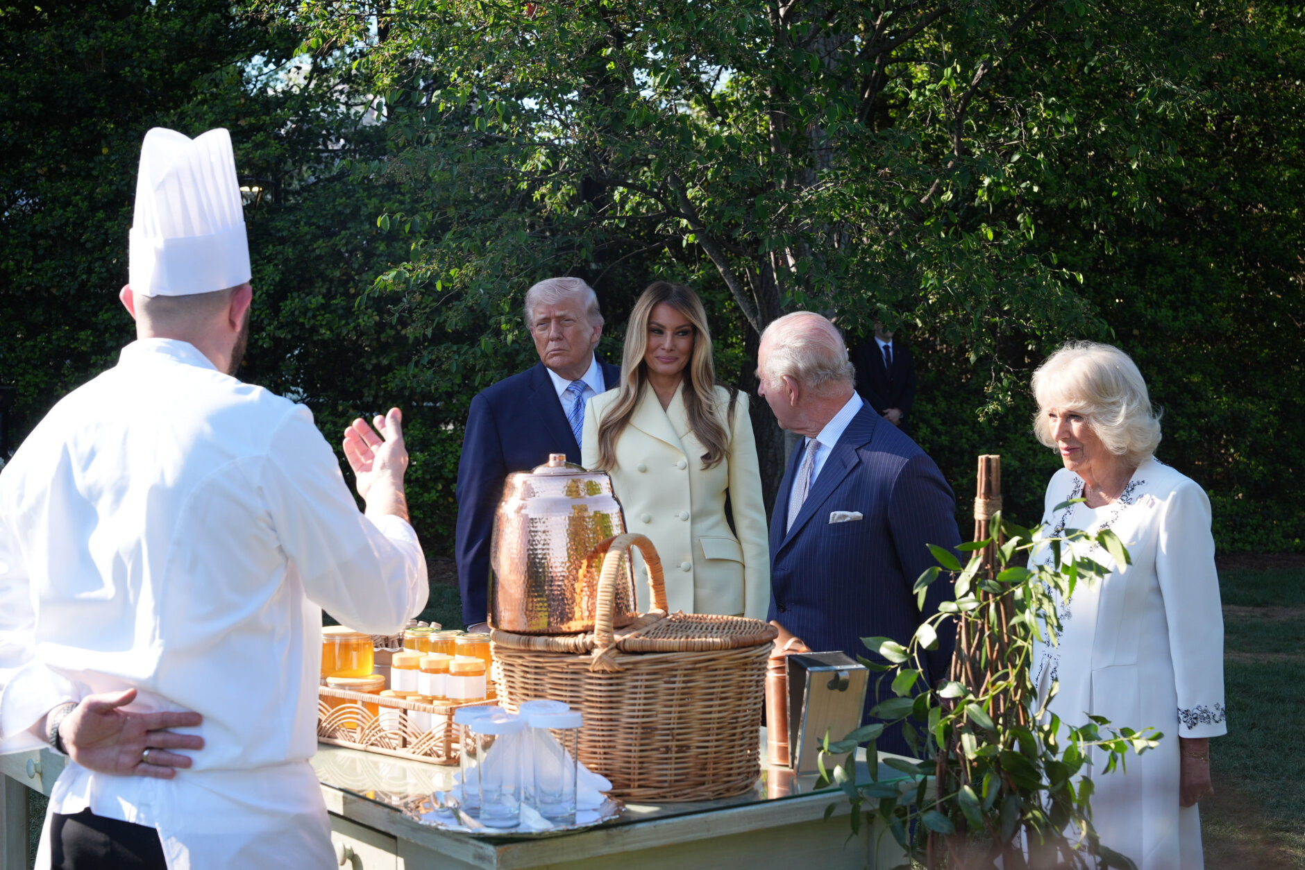 President Donald Trump and first lady Melania Trump andh Britain's King Charles III and Queen Camilla talk with White House assistant pastry chef Carlo Figarella as they look at a display at the White House garden