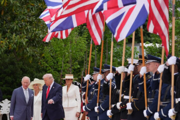 President Donald Trump walks on the red carpet in the Rose Garden with Britain's King Charles III, Queen Camilla and first lady Melania Trump at White House,