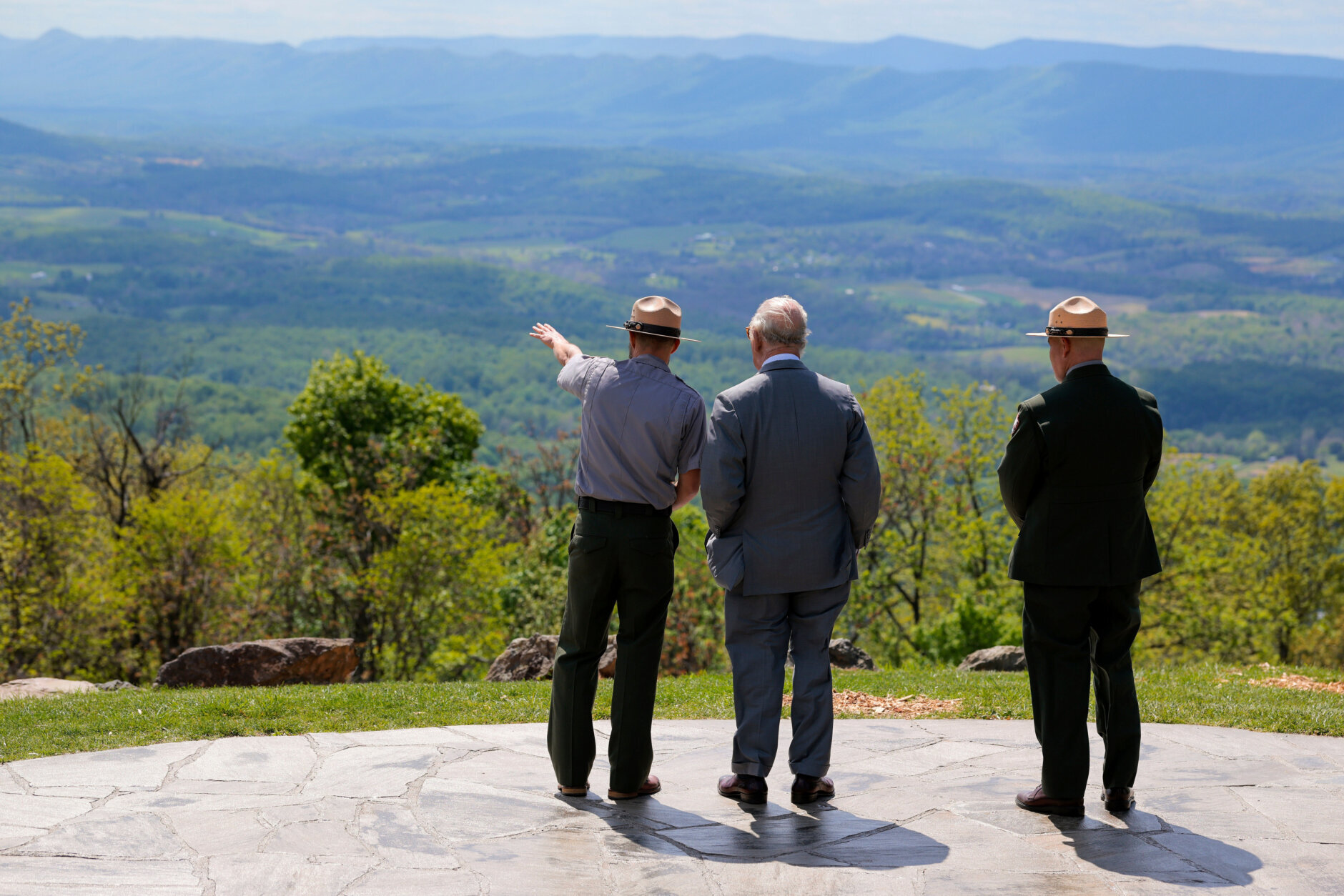 Britain's King Charles III, center, speaks with park officials during a visit to Shenandoah National Park