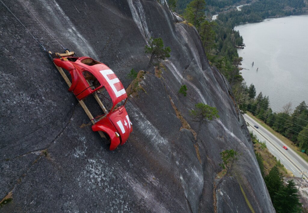 Car shell suspended on rock face above British Columbia highway in apparent prank