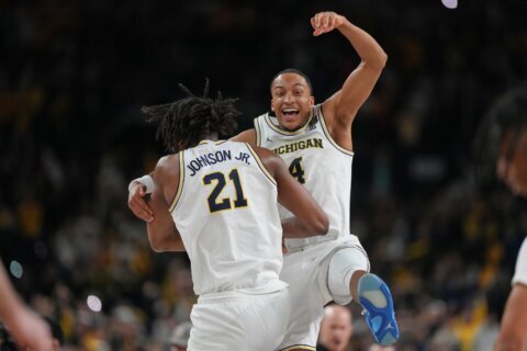 Michigan muscles its way to program’s 2nd national title, beating stubborn UConn 69-63