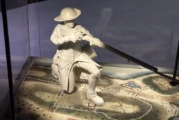 a figurine aiming a firearm