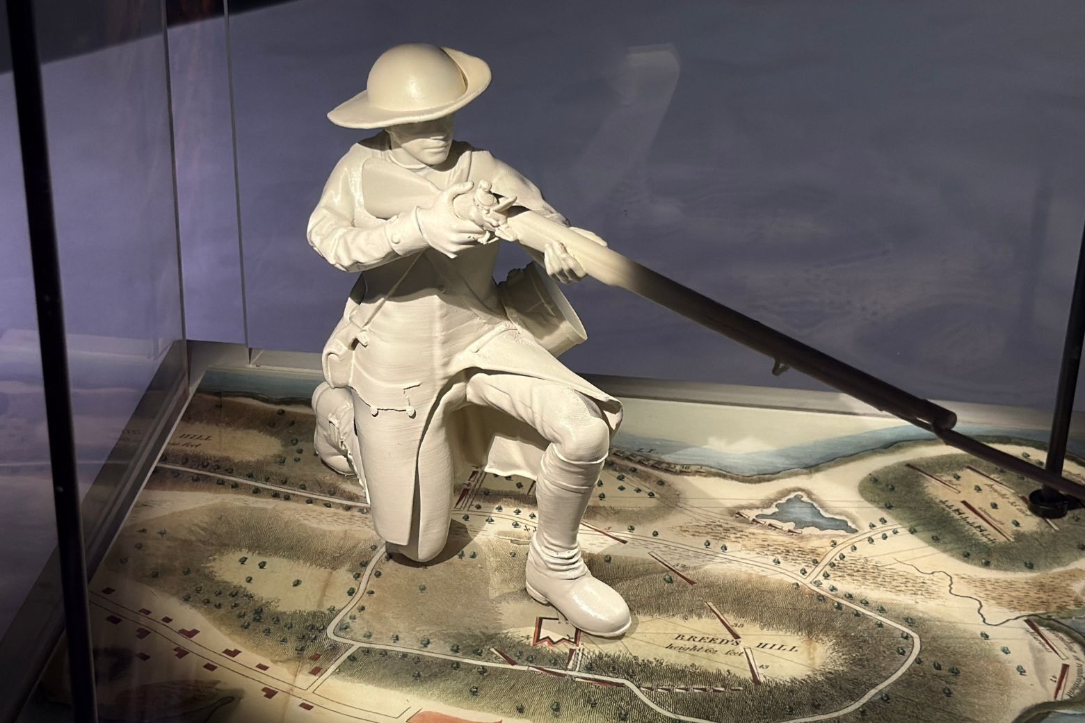 a figurine aiming a firearm