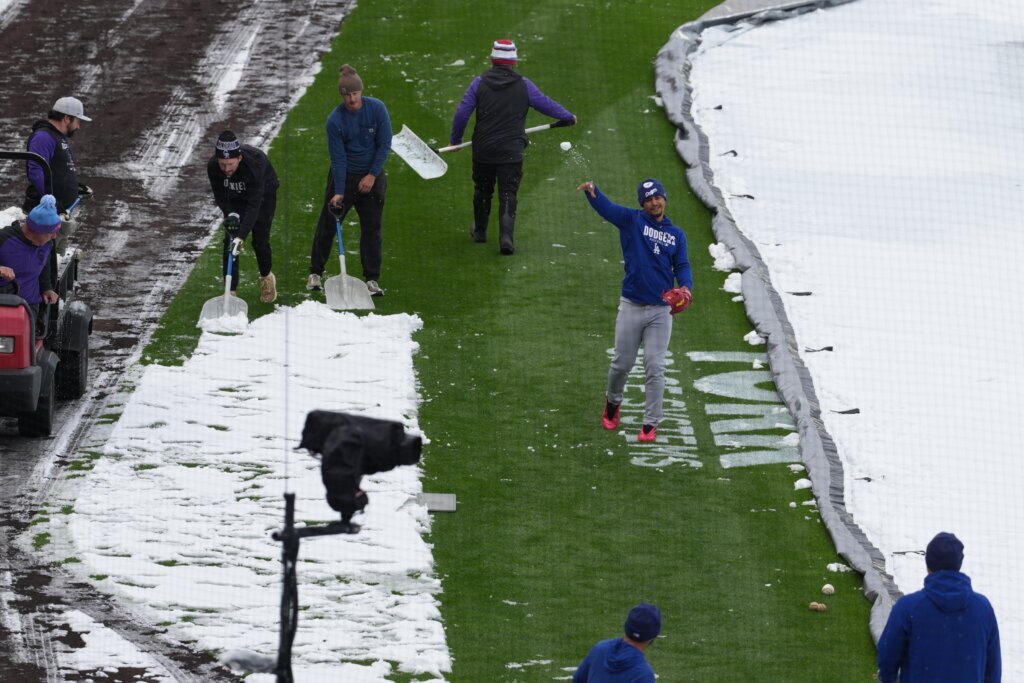Surprise mid-April snow coats Coors Field as Dodgers-Rockies series gets off to frosty start
