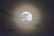 bright moon surrounded by clouds