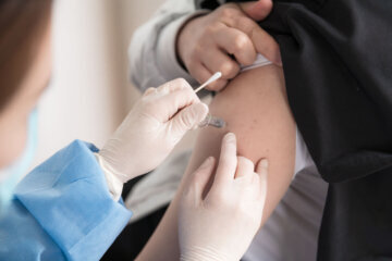An adult getting a vaccination shot