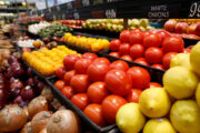 Fresh tomatoes are displayed on a shelf at Bob's Market