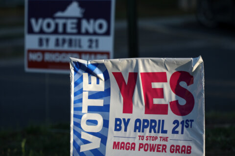 BURKE, VIRGINIA - APRIL 17: Campaign signs are seen at a polling place on April 17, 2026 in Burke, Virginia. Virginia voters will decide on April 21 a statewide ballot question on whether to allow the Virginia General Assembly to redraw congressional districts which could affect how the state’s U.S. House districts are mapped in upcoming elections and shift political balance. (Photo by Alex Wong/Getty Images)