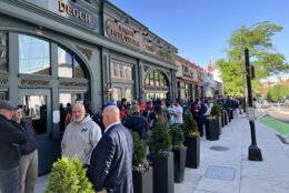 people stand outside of pub